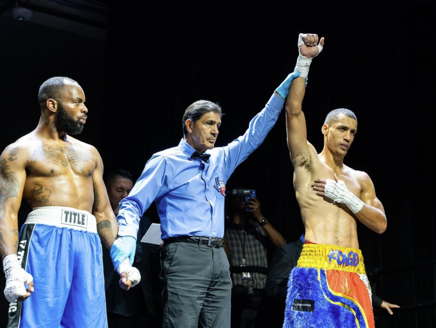 David Kasindi Kongo hand raised in victory after professional boxing win at Ridglea Theater Fort Worth Texas