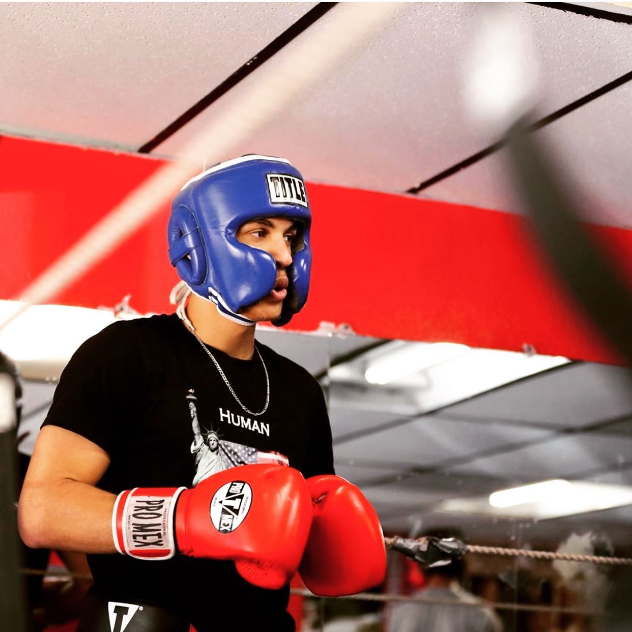 David Kasindi Kongo sparring at Lewisville Boxing Team with blue headgear and red Pro Mex gloves